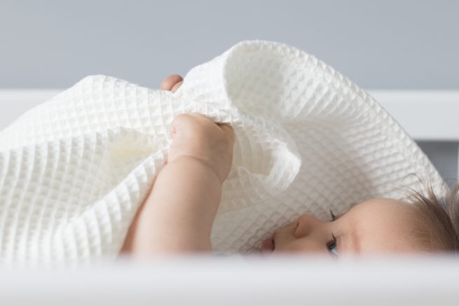 Soft and gentle cotton white waffle baby blanket.